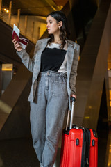 Fototapeta na wymiar Young woman at international airport moving to terminal gate for airplane travel trip - Mobility concept and aerospace industry flight connections