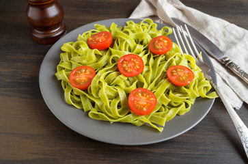 spinach tagliatelle with cherry tomatoes. proper diet.