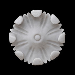White marble flower decoration isolated on black background.