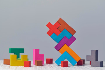 wooden block puzzle. wood cube stacking. Concept of complex and smart logical thinking. Slightly...