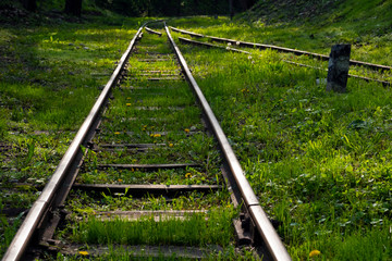 Railway in rural area. Old railway through green forest.