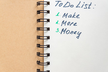 To do list - make more monTo do list - make more money written text on note pad. Close upe written...