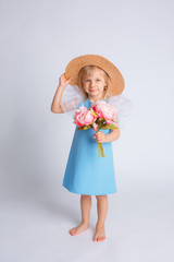 baby girl with a bouquet of flowers and a straw hat on a white background