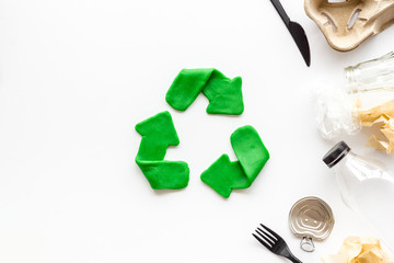 Recycle concept. Green arrows icon among waste on white background top-down copy space