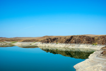 Blue lake in steppe canyon with blue sky. Natural landscape. Beautiful landscape. Beauty nature background. Beautiful sky. Kurty or Kurtinskoye lake.