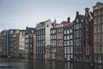 Fototapeta premium nice colored houses, thin and tall. They are old and are built in front of the canal