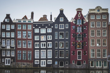 Fototapeta premium nice colored houses, thin and tall. They are old and are built in front of the canal