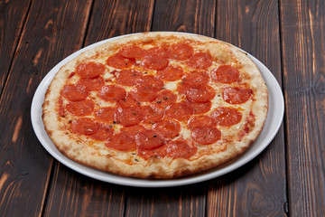 tasty pizza on the wooden background