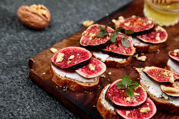 Bruschetta  or ctostini with cottage cheese, figs and honey. Sandwich with figs and goat cheese..