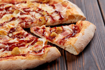 tasty pizza on the wooden background