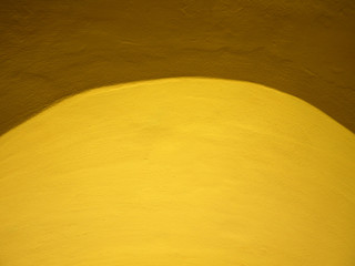 Yellow cement wall background.