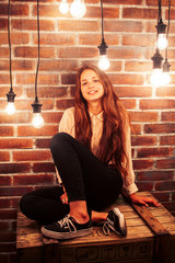 young teenage girl posing cheerful in modern loft studio interior with many lights, lifestyle holiday people concept