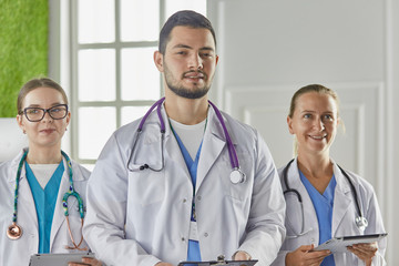 Portrait of group of smiling hospital colleagues standing together