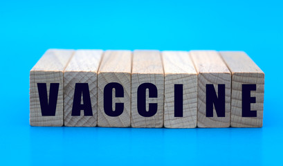 concept word vaccine on wooden cubes on a blue background