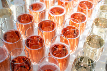 Rows of glasses of red prosseco and champagne