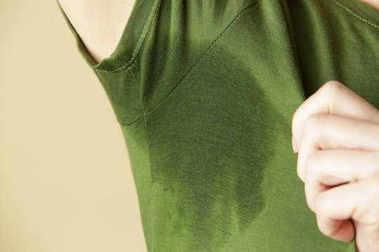 Close Up Image Of Woman In Green T-shirt With Sweat Patch Under Armpit