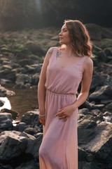 Girl with a tattoo on the beach, femininity, a walk on the beach at sunset. Vertical shot, Oregon USA, Cannon Beach