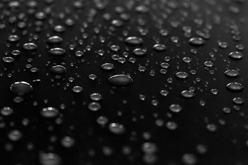 Water drops on a shiny surface, selective focus. Rain drops. Abstract background.