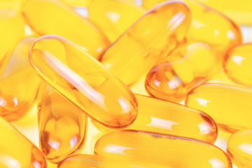Close up of Fish oil capsules with omega 3. Health care concept.
