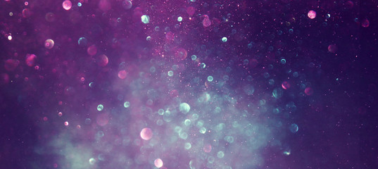 background of abstract glitter lights. gold, blue and black. de focused