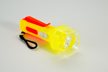 Children's flashlight bright plastic with LED. Background for children's toys.