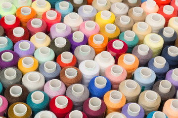 Sewing threads multicolored background closeup