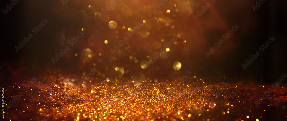 Wall mural background of abstract glitter lights. gold, blue and black. de focused