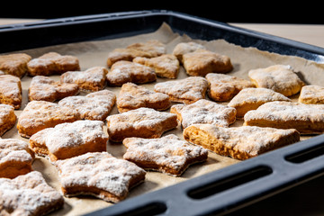 Homemade pastry of various shapes on a baking pan, freshly baked, concept, homemade food.