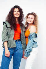 young pretty teenage girls friends with blond and brunette curly hairs posing cheerful isolated on white background, lifestyle people concept