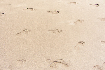 Footprints of a man in the light sand
