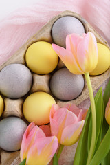 Obraz na płótnie Canvas top view Easter eggs with tulips