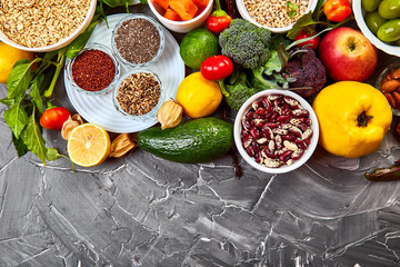 Balanced food background, organic food for healthy nutrition on grey backgound. Top view, flat lay, copy space.