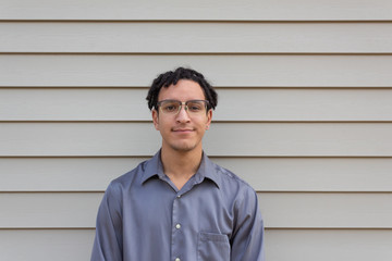 Pleasant young man in glasses, natural black hair in dreads, mixed race millennial, horizontal aspect