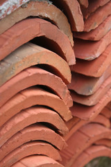 Close-up of old red roof tiles. Titles made of terracotta on selective focus