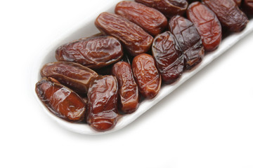 Dried dates ina plastic bowl isolated on white background. Date fruits on white