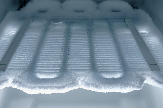 Time to defrost : View into the freezer on cooling coils completely covered with ice.