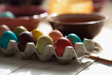  colorful Row dyed Easter eggs in a carton on table 