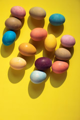 Happy Easter. Colorful Easter eggs on yellow background