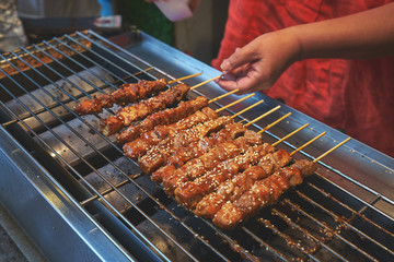 Grilled meat on the wooden sticks. Traditional asian street food