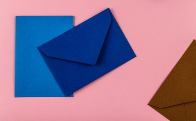 Colorful envelopes on a pink background.