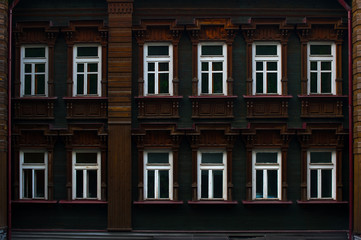 Obraz premium wall of brown wooden house with white windows