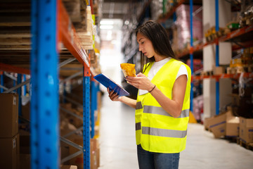 Workers in warehouse review the goods	