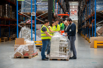 Warehouse staff meeting, workers with mnagers	