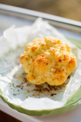 Whole Roasted Cauliflower in a green plate