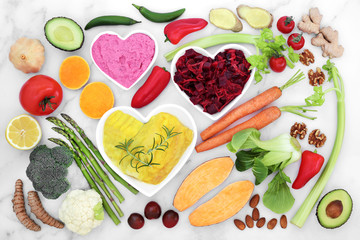 Health food for a healthy heart & cardiovascular system with fruit, vegetables, fish, dips, nuts, spice and herbs. High in omega 3, antioxidants, protein, anthocyanins & fibre with a low GI. Flat lay.
