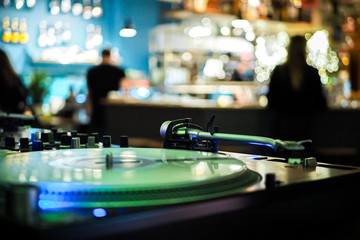 Fototapeta na wymiar DJ vinyl players in dark nightclub, party in the dance club, DJ equipment, defocused