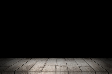 Wooden table with dark blurred background.