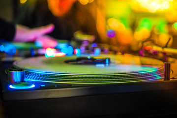 DJ vinyl players in dark nightclub, party in the dance club, DJ equipment, defocused