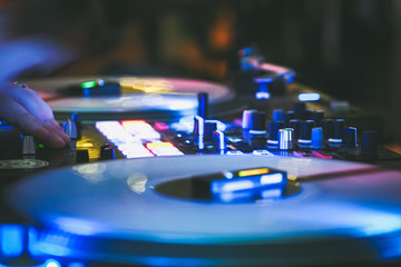 DJ vinyl players in dark nightclub, party in the dance club, DJ equipment, defocused