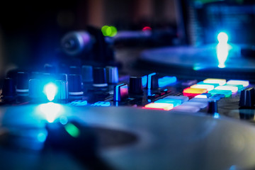 DJ vinyl players in dark nightclub, party in the dance club, DJ equipment, defocused	
